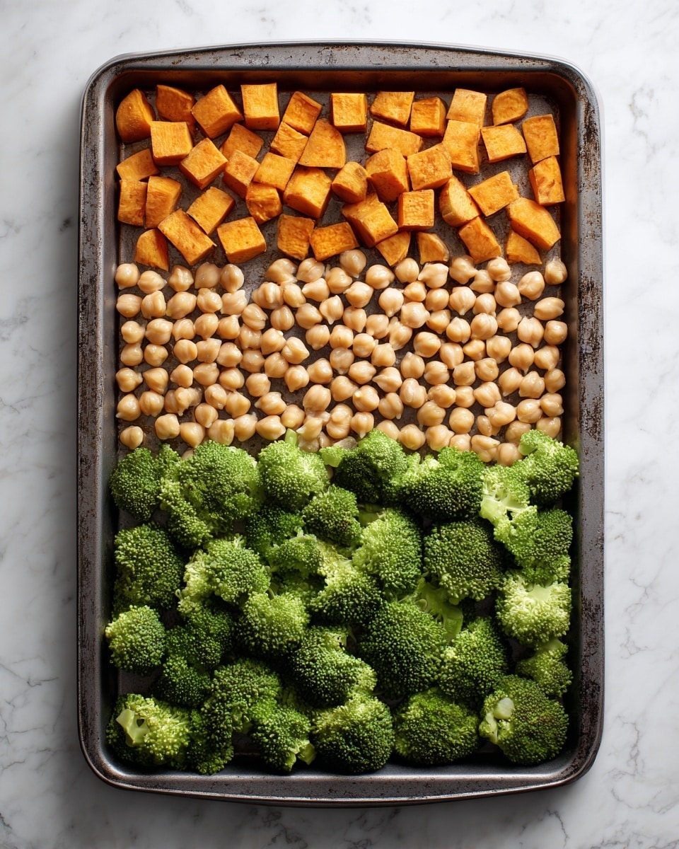 A baking tray filled with three sections of food: at the top, small orange cubes of sweet potatoes spread evenly; in the middle, light beige round chickpeas arranged in a neat layer; and at the bottom, bright green broccoli florets covering the area. The tray is placed on a white marbled textured surface. Photo taken with an iphone --ar 4:5 --v 7