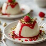 Creamy Vanilla Panna Cotta with Raspberry Coulis and Gourmet Toppings Recipe