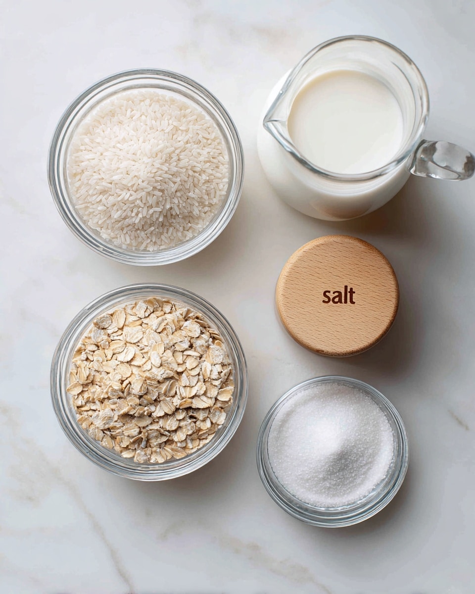 There are five clear glass bowls and containers on a white marbled surface. The top left bowl is filled with uncooked white rice, showing its small, smooth grains. Below it to the left is another bowl filled with light beige rolled oats that have a rough texture. In the center is a small white bowl filled with fine white salt. To the right of that is a small clear bowl with a wooden lid that has the word